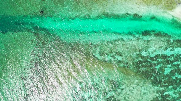 Luxury overhead island view of a white paradise beach and blue ocean background in colorful 4K