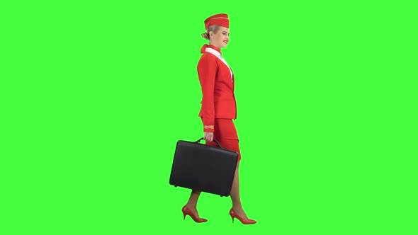 Stewardess Walks with a Briefcase in Her Hands. Green Screen. Side View