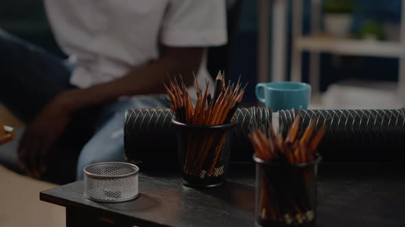 Close Up of Art Tools and Colorful Pencils on Workshop Table