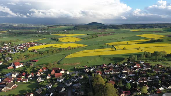 Aerial view of a German village surrounded by rapeseed fields, Marbach, Germany.