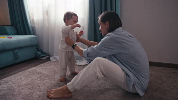 Slow Motion of Lovely Caucasian Baby Boy Learning to Walk Taking First Step Walk to His Mother at