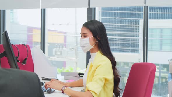 Portrait of business woman wear mask, working in office with new normal social distancing lifestyle.