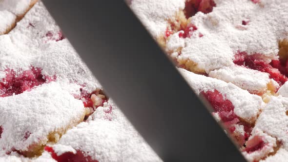 Tasty cherry cake cutting  on smaller pieces 4K2160p UHD footage - Cherry sponge cake powdered with 