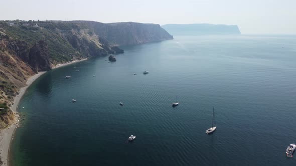 Aerial View From Above on Calm Azure Sea and Volcanic Rocky Shores