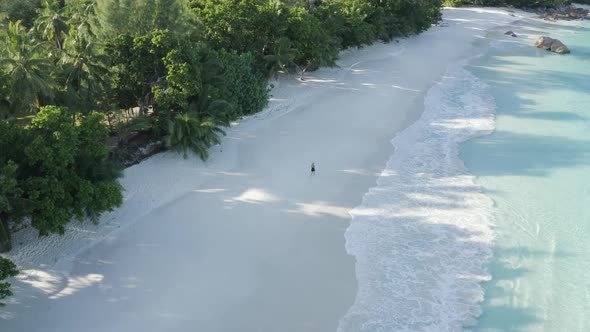 Aerial view of a person walking on the beach of Anse Lazio, Seychelles.