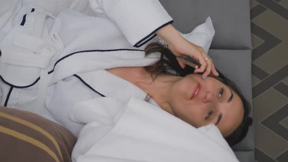 Woman in Bathrobe Drying Hair After Shower