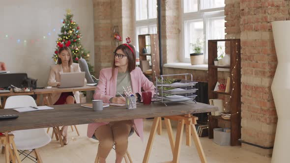 Businesspeople Working in Office on Christmas