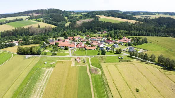 Aerial Drone Shot  a Village Surrounded By Fields and Forests in a Rural Area  Drone Flies Forward