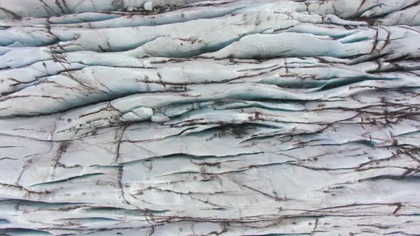 Svinafellsjokull Glacier. Ash, Cracks and Crevasses. Iceland. Aerial Top-Down View