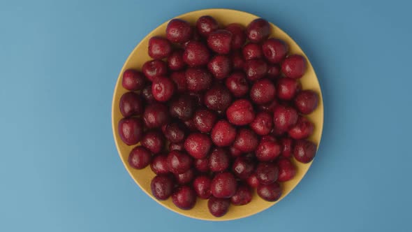 Dark Red Cherries on a Rotating Plate