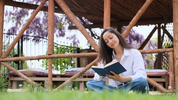 Woman Relax in the Garden Reads Book