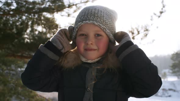 Girl Posing Against Snowy Winter Landscape