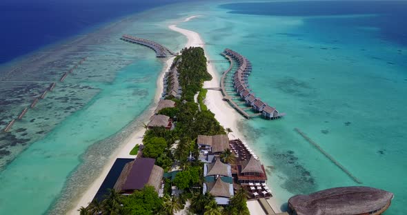 Luxury birds eye travel shot of a white sand paradise beach and aqua blue water background 