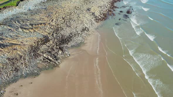 Aerial view over a natural rock formation on  Irish beach