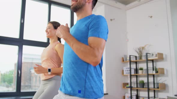 Happy Couple Exercising at Home