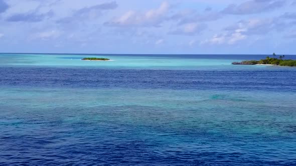 Aerial nature of resort beach by blue water and sand background