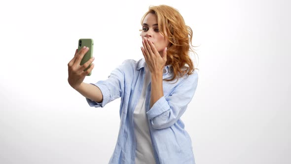 Cheerful Woman Blow Kiss on Smartphone Camera Posing for Photo Selfie