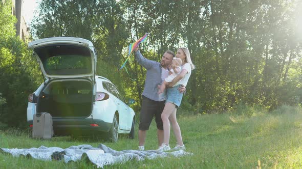 A Happy Family is Resting Outside the City and Traveling By Car