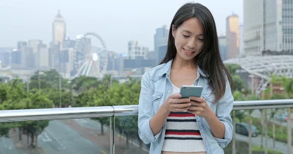 Woman using smart phone in the city