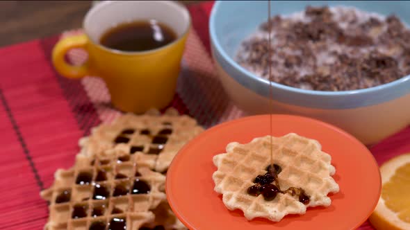 Breakfast buffet with waffles, coffee, muesli and orange