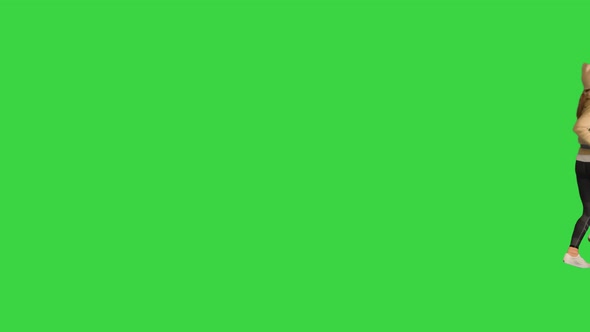 A Young Girl in a Hat Running By on a Green Screen Chroma Key