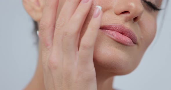 Closeup Beauty Portrait of Young Woman Softly Touches Her Chin with a Back of Her Hand Gently Lays