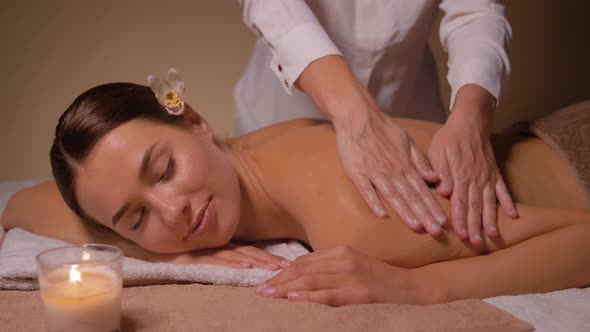 Woman Lying and Having Back Massage at Spa