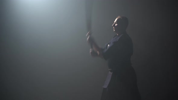 Kendo Instructor Practicing Martial Art with the Katana Shinai at Dark Studio.