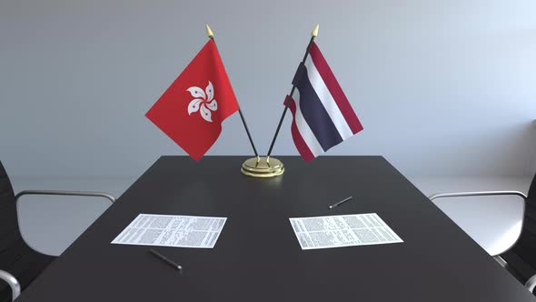 Flags of Hong Kong and Thailand on the Table