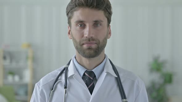 Cheerful Young Doctor Showing Thumbs Up