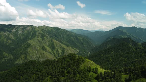 A Camera Hit a Mountain Range Covered with Green Trees