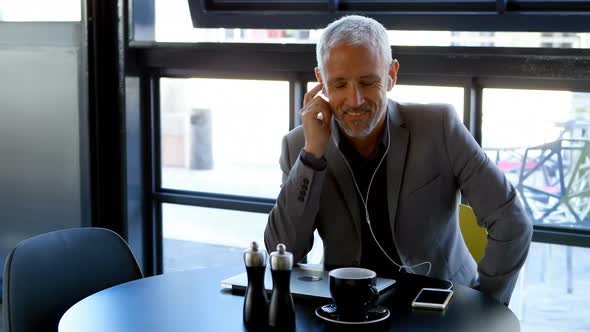 Businessman talking on mobile phone in hotel 