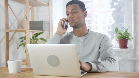 AfroAmerican Man Talking on Phone Attending Phone Call