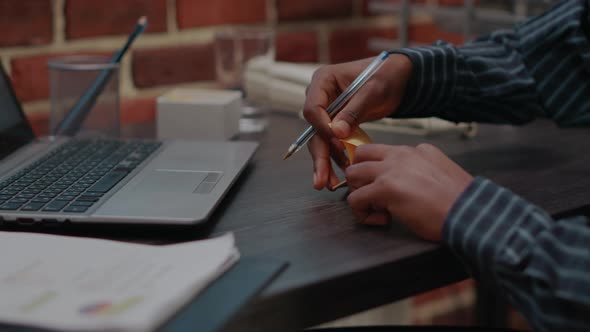 Business Man Putting Adhesive Post It Paper on Laptop Display