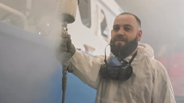 Bearded Man Spraying Paint on Camera