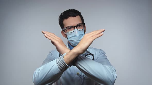 Portrait of a Doctor with Stubble in a White Lab Coat and a Stethoscope Around His Neck Arms Crossed