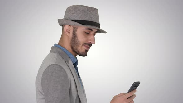 Casual Man Texting on Phone and Walking on Gradient Background.