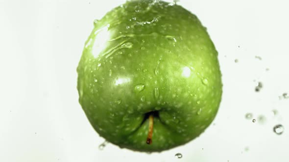 Flying of Green Apple in White Kitchen Background in Slow Motion