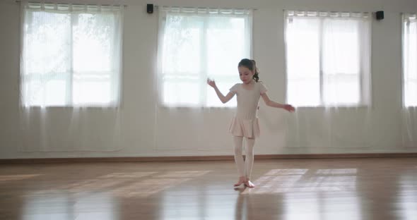 Little girl dancing alone in a studio