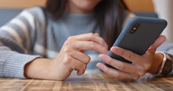 Woman use of mobile phone in restaurant