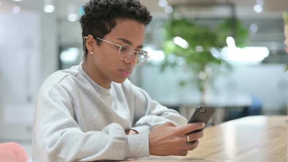 Young Casual African Woman Using Smartphone