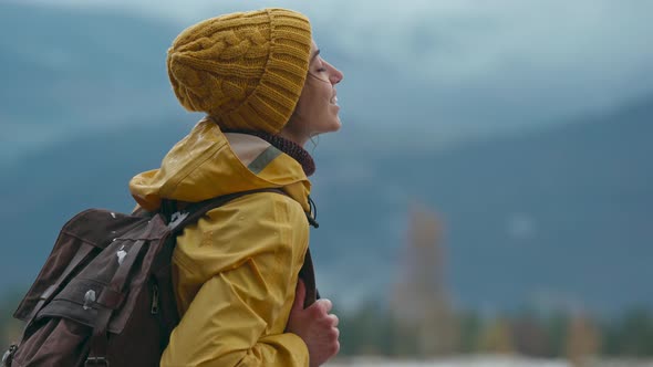 Beautiful Woman in Yellow Wear Stands in Forest Looks Up Inhale and Breathe in Fresh After Rain Air