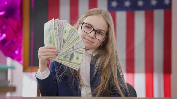 Medium Shot of Confident Satisfied Teen Schoolgirl Shaking Money As Fan Looking at Camera Smiling