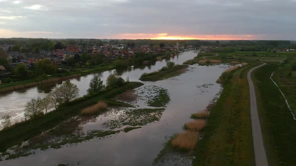 Panoramic aerial view of swamp and houses in background at sunset