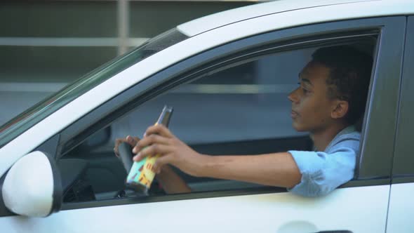 Irresponsible African-American Teenager Drinking Beer Driving Car, Accident Risk