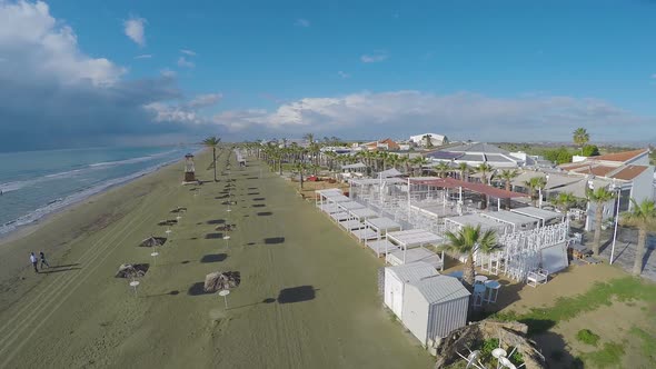 Aerial View Along Beach in Cyprus, Straw Parasols and Chaise-Longues, Larnaca