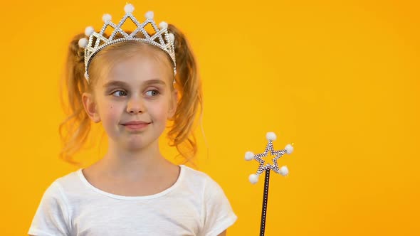 Cute Blonde Kid Waving Magic Wand and Smiling on Camera, Dreams and Childhood