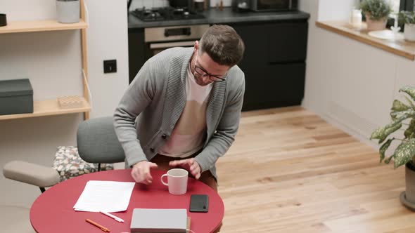 Man Looking Through Documents at Home