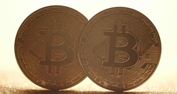 Close Up New Virtual Currency Bitcoin BTC Coin on Gold Background with Bokeh