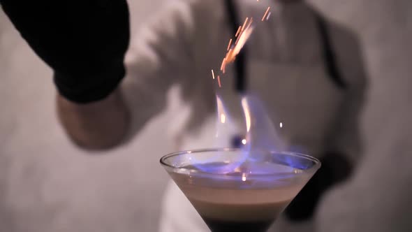 Bartender Strew Cinnamon Powder to Flame of Cocktail